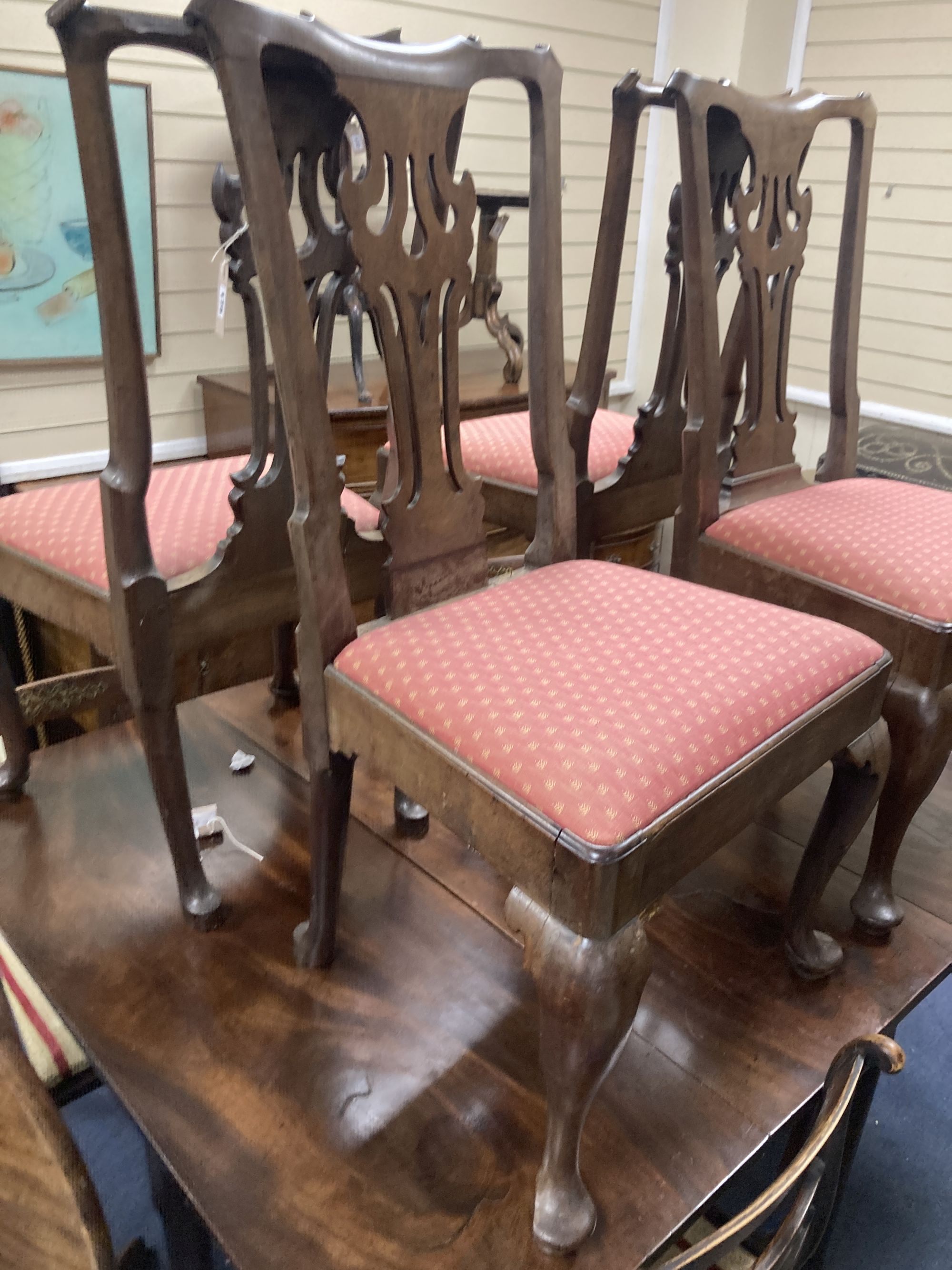 A set of four mid-18th century walnut / mahogany dining chairs